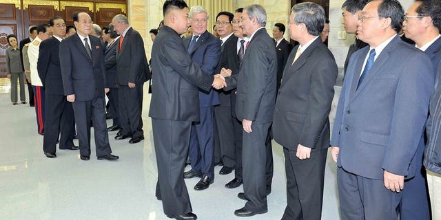 This undated photo released by North Korea's official Korean Central News Agency (KCNA) on July 28, 2013 shows North Korean leader Kim Jong-Un (centre L) welcoming head of the International Department of the Central Committee of the Communist Party of Cuba Jose Ramon Balaguer (centre R) in Pyongyang. Cuba said it was looking forward to closer cooperation with North Korea after "favorable" talks.