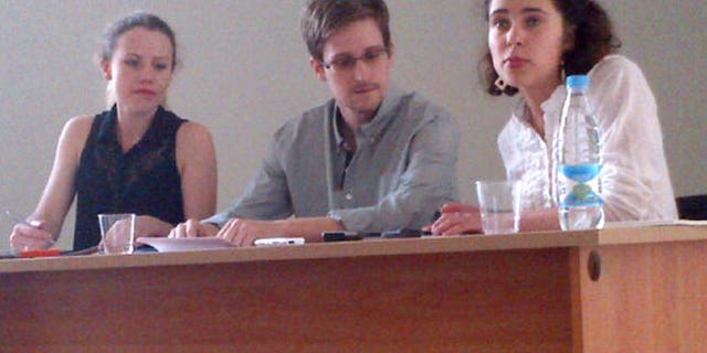 A picture released by Human Rights Watch shows Edward Snowden (C) during a meeting with rights activists, among them Sarah Harrison of WikiLeaks (L), at Moscow's Sheremetyevo airport, on July 12, 2013. Brazil-based Guardian reporter Glenn Greenwald said Tuesday that he had received nearly 20,000 secret US government documents from intelligence leaker Snowden.