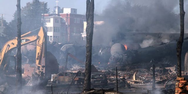 Wrecked oil tankers and debris are shown July 8, 2013 after a runaway train derailed and exploded in Lac-Megantic, Quebec. Montreal, Maine & Atlantic , the owners of the train, have filed for bankruptcy.