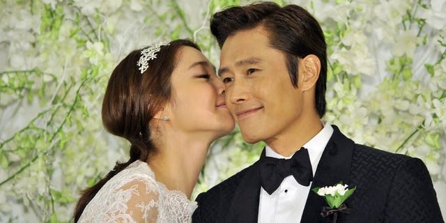 South Korean actor Lee Byung-Hun poses with actress Lee Min-Jung during a press conference before their wedding in Seoul, on August 10, 2013. Lee Byung-Hun is one of the best known faces of the "Korean Wave" of popular culture.