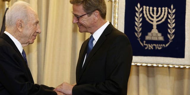 German Foreign Minister Guido Westerwelle (R) is greeted by Israeli President Shimon Peres (L) at the presidential residency in Jerusalem on August 11, 2013. Westerwelle met Sunday with Israeli officials on a visit to support nascent peace talks, offering to try to soften a European ban on dealings with Jewish settlements.