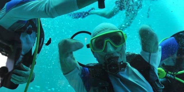 Philippe Croizon celebrates underwater on January 10, 2013 after becoming the first quadruple amputee to dive to a depth of 33 metres, in the deepest swiming pool in the world in Brussels.