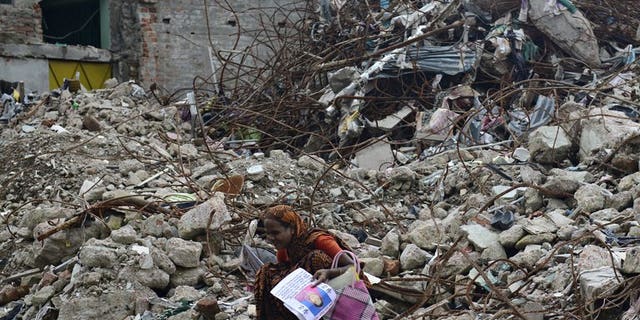A mourner grieves for her relative, missing and presumed dead, at the scene of the April 24 Rana Plaza garment building collapse on the 100-day anniversary of the disaster in Savar, on the outskirts of Dhaka, on August 2, 2013. A Bangladeshi garment worker who spent 108 days in a coma after being badly injured in one of the world's worst industrial disasters has died, officials said on Monday.
