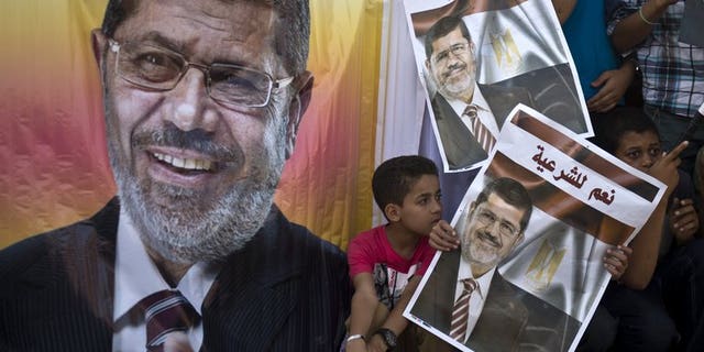 Supporters of deposed Egyptian president Mohamed Morsi watch a football match between the two main Cairo protest camps by members of the Muslim Brotherhood and supporters of the ousted Islamist leader in Cairo on August 11, 2013. Egypt's judiciary said Monday it was extending ousted president Mohamed Morsi's detention for a further 15 days pending an investigation into his collaboration with Hamas.