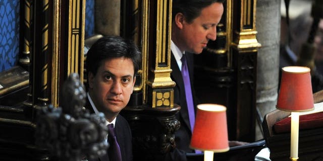 Prime Minister David Cameron (R) and Labour leader, Ed Miliband, are shown at Westminster Abbey in London on June 4, 2013. Miliband was delivered a further blow on Tuesday when a new poll showed that faith in the Conservative's handling of the economy had soared.