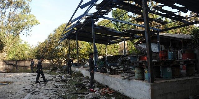 Thai police inspect a gas factory after a bomb blast in the restive southern province of Narathiwat, on August 11, 2013. A policeman has been killed and nine other people wounded in a bomb attack in Thailand's insurgency-hit deep south, as authorities vowed talks with rebels will continue.