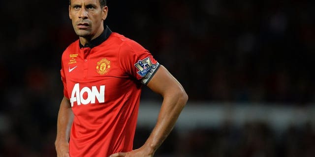 Manchester United's English defender Rio Ferdinand pictured during his testimonial match against Sevilla at Old Trafford in Manchester, northwest England on August 9, 2013. Ferdinand claims that the current national side have lost their identity and has called for an overhaul of the national coaching strategy.