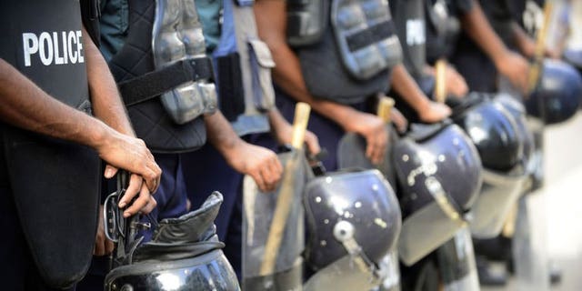 Bangladeshi police stand guard during a nationwide strike called by the Jumaat-e-Islami party in Dhaka, on August 13, 2013. Bangladesh police have fired rubber bullets and tear gas at supporters of the country's largest Islamist party as they protested against a ban preventing it from contesting next year's general elections.