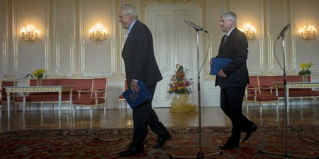 Czech President Milos Zeman (L) and Prime Minister Jiri Rusnok leave after Zeman accepted the resignation of Rusnok and his cabinet on August 13, 2013 at Prague Castle in Prague. The Czech government formally resigned on Tuesday after losing a confidence vote last week, ahead of snap elections to drag the country out of a deepening political crisis.