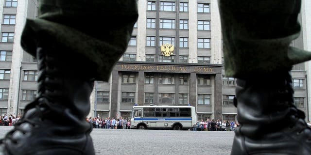 A soldier stands guard in front of the State Duma in Moscow, on July 18, 2013. Russian police have arrested a Siberian surgeon on suspicion of stealing heroin that he had extracted from the stomach of a drug mule.