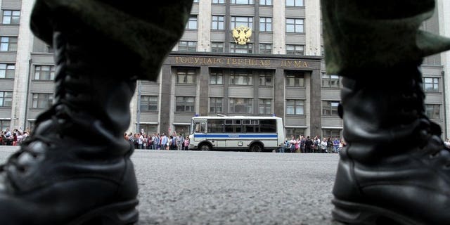 A soldier stands guard in front of the State Duma in Moscow, on July 18, 2013. Russian police have arrested a Siberian surgeon on suspicion of stealing heroin that he had extracted from the stomach of a drug mule.