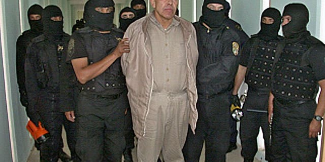 This file photo shows Rafael Caro Quintero (C), a drug lord convicted of killing a US drug agent in 1985, under custody at the 'Puente Grande' prison in Guadalajara, on January 29, 2005. Caro Quintero had another 12 years to go in his sentence, and could have faced additional charges in the US, but on August 7 a judge in the western state of Jalisco ordered his release on a technicality.