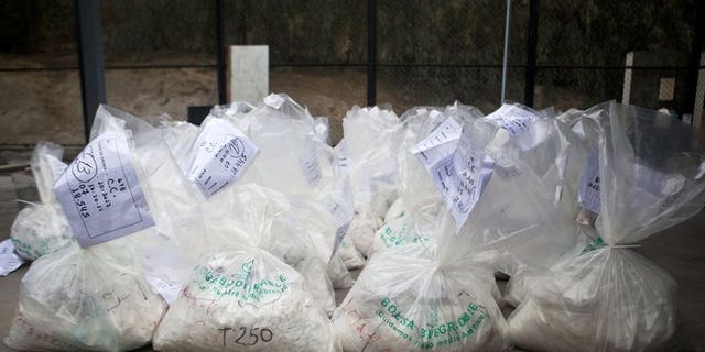 This file photo shows bags filled with cocaine, to be burned by workers of the Peruvian Ministry of Interior, at a police facility on the outskirts of Lima, on October 30, 2012. Two British women caught in Peru with ??1.5 million worth of cocaine claim that Ibiza gangsters forced them at gunpoint into becoming drug mules, in comments published in Wednesday's Daily Mirror.