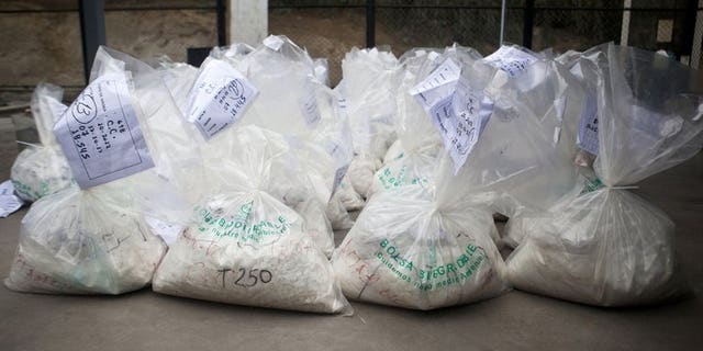 This file photo shows bags filled with cocaine, to be burned by workers of the Peruvian Ministry of Interior, at a police facility on the outskirts of Lima, on October 30, 2012. Two British women caught in Peru with ??1.5 million worth of cocaine claim that Ibiza gangsters forced them at gunpoint into becoming drug mules, in comments published in Wednesday's Daily Mirror.