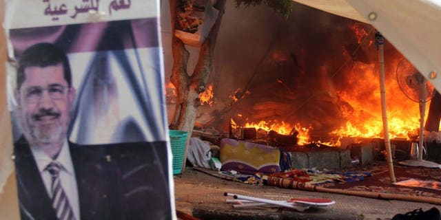 A protest camp is torched in Cairo's al-Nahda Square, on August 14, 2013. Supporters of deposed Islamist president Mohamed Morsi have torched a church in Sohag in a reprisal attack after police dispersed demonstrations in Cairo, according to the MENA state news agency.