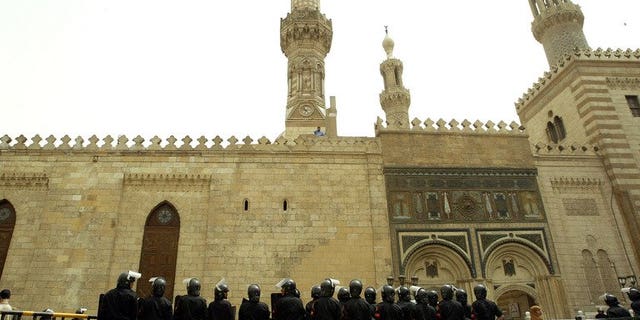 Egyptian riot police guard the entrance of al-Azhar mosque in Cairo, on April 4, 2003. Al-Azhar -- Sunni Islam's main seat of learning -- has distanced itself from the crackdown on protesters loyal to ousted president Mohamed Morsi which left dozens dead.