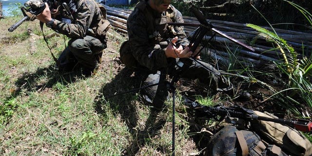 US soldiers prepare communication equipment during a joint exercise on the shore of Ulugan Bay, on Palawan island, on April 25, 2012. The Philippines and the United States have begun talks aimed at allowing a bigger US military presence on the soil of its key Asian ally, amid tensions with China.