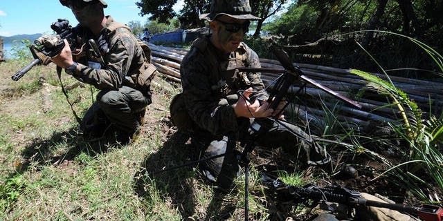 US soldiers prepare communication equipment during a joint exercise on the shore of Ulugan Bay, on Palawan island, on April 25, 2012. The Philippines and the United States have begun talks aimed at allowing a bigger US military presence on the soil of its key Asian ally, amid tensions with China.