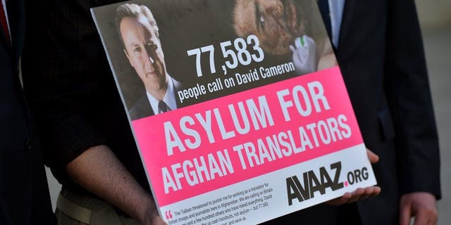A man holds a petition in London calling for asylum for Aghan interpreters who served the British army on May 3, 2013. Winston Churchill's great-grandson delivered a petition with more than 70,000 signatures to Prime Minister David Cameron's office, demanding action to protect Afghan interpreters who have served with British troops.