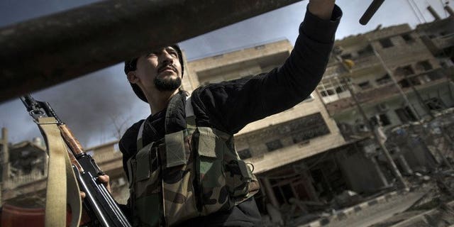 A Free Syrian Army fighter moves during clashes with regime forces on February 28, 2013 in Deir Ezzor. A jihadist group has expelled rebel Free Syrian Army fighters from their positions in the northern city of Raqa, a watchdog reported on Wednesday.