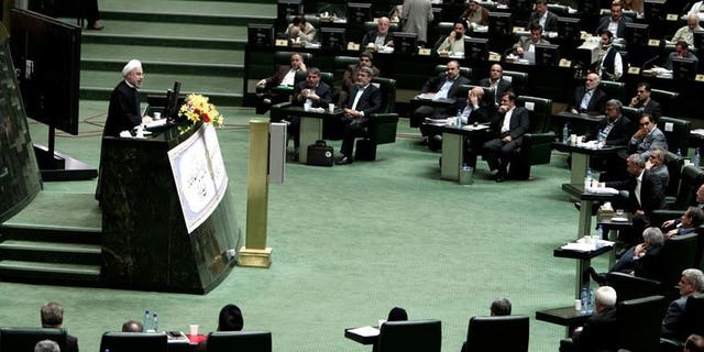 Iranian President Hassan Rowhani speaks during a parliament session to elect the cabinet members on August 15, 2013 in Tehran. Iran MPs approved 15 of Rowhani's 18 cabinet picks.