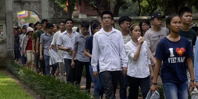 Students walk inside the temple of literature at Vietnam's first national university on July 2, 2013 as they come to pray for luck prior to the admission exams for a college seat. Vietnam is offering free classes in Marxism, Leninism and the teachings of Ho Chi Minh in a bid to revive interest in the ideology behind the country's system of government.