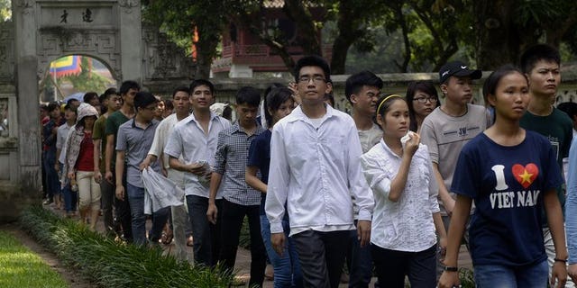Students walk inside the temple of literature at Vietnam's first national university on July 2, 2013 as they come to pray for luck prior to the admission exams for a college seat. Vietnam is offering free classes in Marxism, Leninism and the teachings of Ho Chi Minh in a bid to revive interest in the ideology behind the country's system of government.
