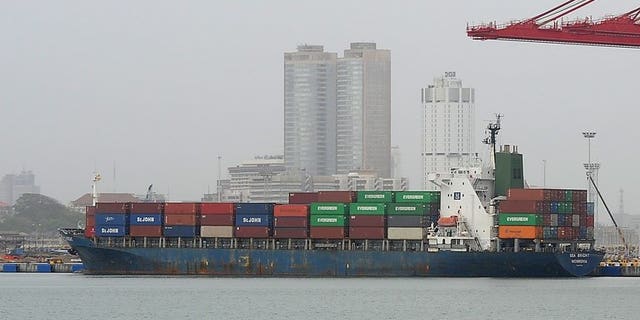 Illustration: a container ship is pictured at the Chinese-built harbour in Sri Lanks on July 24, 2013. China will cut days from each journey its ships make to Europe by using the Northeast Passage through the Arctic Ocean