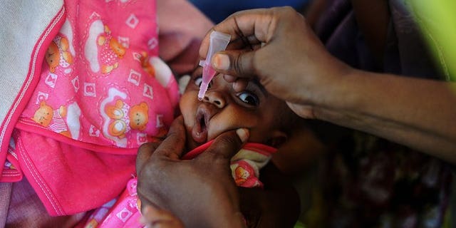 A Somali baby is given a polio vaccination before being given a pentavalent vaccine injection at a medical clinic in Mogadishu on April 24, 2013. Somalia are struggling to contain a dangerous outbreak of the crippling polio virus, with rampant insecurity hampering efforts, the United Nations said Friday.