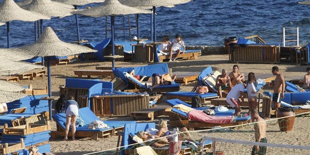 Foreign tourists enjoy the sunny weather in the Egyptian Red Sea resort of Sharm el-Sheikh, on January 3, 2012. Egypt's tourist industry is facing meltdown as foreign governments warn their citizens to stay away and told visitors already there to remain in their hotels.