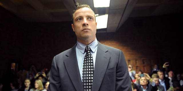 A file picture taken on June 4, 2013 shows South African Paralympic sprinter Oscar Pistorius appearing at the Magistrate Court in Pretoria. Pistorius will go on trial in March next year on murder charges for shooting his girlfriend, his lawyer said Saturday.