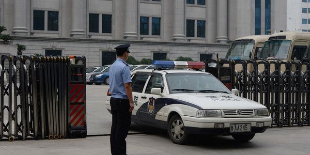 Police leave the Intermediate People's Court in Jinan, Shandong Province on July 25, 2013. Chinese police have detained a prominent human rights activist, signalling the continuation of a recent crackdown on dissent, an advocacy group said on Saturday.