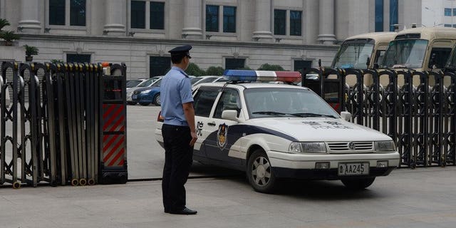 Police leave the Intermediate People's Court in Jinan, Shandong Province on July 25, 2013. Chinese police have detained a prominent human rights activist, signalling the continuation of a recent crackdown on dissent, an advocacy group said on Saturday.