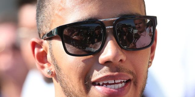 Lewis Hamilton speaks to the press at the Hungaroring circuit in Budapest on July 28. Mercedes team chief Ross Brawn believes that Hungarian Grand Prix winner Hamilton still has much more to offer to the team despite his recent surge of excellent form.