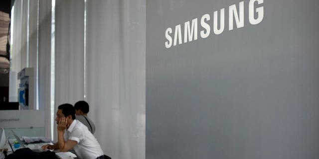 A Samsung logo is displayed at a showroom in Seoul on July 5, 2013. South Korea's Samsung Electronics will unveil its new Galaxy Gear "smartwatch" early next month, ahead of Apple's iWatch, Bloomberg news and a fan site said Saturday.