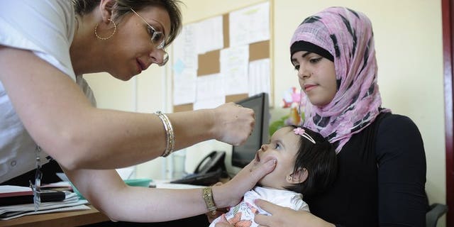 A Bedouin child receives a vaccine against polio at a clinic in Rahat on August 5, 2013. Israel took its polio vaccination campaign nationwide on Sunday, saying a two-week vaccination effort in the south was not enough to curb the threat of an outbreak of the virus.