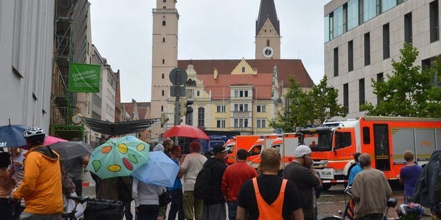 Onlookers stand in a street near the town hall in Ingolstadt, southern Germany, on August 19, 2013. A man claiming to be armed took several hostages in the town hall on Monday, police said.