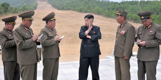 Undated recent photo released by North Korea's official Korean Central News Agency on May 27, 2013 claims to show North Korean leader Kim Jong-Un (C) talking to army officials at the Masik Pass Skiing Ground under construction by the Korean People's Army. Switzerland said Monday that it had blocked a deal to sell top-notch ski lifts to North Korea, in a move that could delay the ski project.