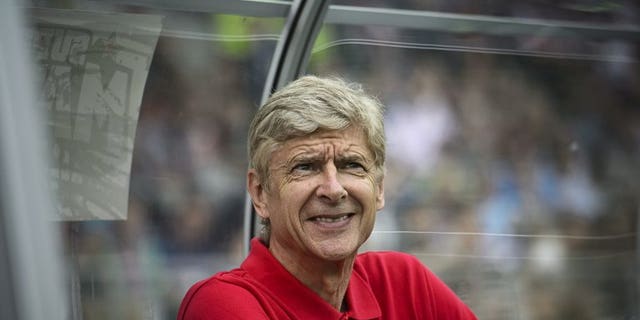 Arsenal's Manager Arsene Wenger follows the pre-season match between Premier League giants Manchester City and Arsenal in Helsinki on August 10, 2013. Wenger received some welcome news when five players feared to have contracted injuries at the weekend reported for training.