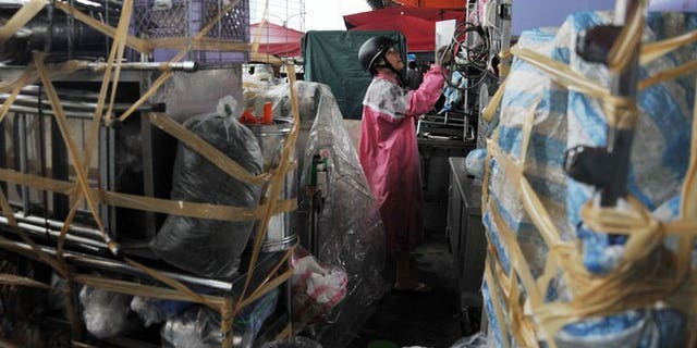Residents pack up their food stands in preparation for Tropical Storm Trami in Taipei on August 20, 2013. Taiwan evacuated more than 1,000 tourists from an island and deployed troops on August 20 in preparation for the possible arrival of Tropical Storm Trami.