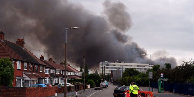 File picture of a fire at a recycling centre in Smethwick, Birmingham, on July 1. Around 50 firefighters were on Wednesday battling a huge fire at a recycling plant near Manchester, the fire service said.