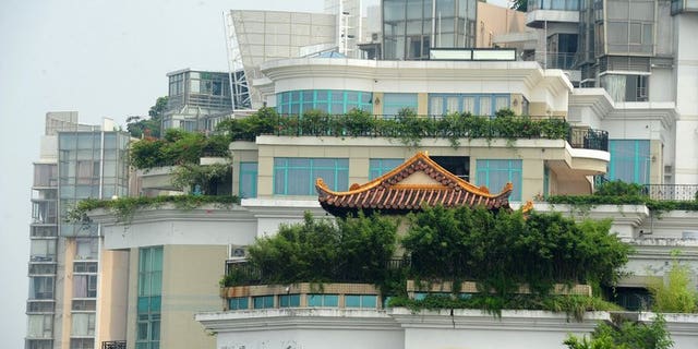 A temple is seen on the rooftop of a 21-storey apartment building in Shenzhen, south China's Guangdong province on August 21, 2013. The latest rooftop architectural wonder highlighted in China is a temple that brings worshippers closer to the heavens by being on top of a 21-storey apartment block.