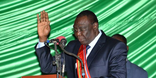 Former rebel leader Michel Djotodia takes the oath during a swearing-in ceremony on August 18, 2013 in Bangui. At least 11 people were killed and 35 injured in clashes that erupted when the new Central African Republic government tried to disarm supporters of ousted leader Francois Bozize, hospital sources said Wednesday.