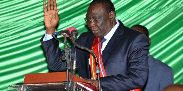 Former rebel leader Michel Djotodia takes the oath during a swearing-in ceremony on August 18, 2013 in Bangui. At least 11 people were killed and 35 injured in clashes that erupted when the new Central African Republic government tried to disarm supporters of ousted leader Francois Bozize, hospital sources said Wednesday.