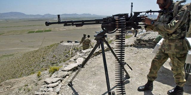 Pakistani soldiers take position at Sholam Post, a military checkpost overlooking Wana, the mountain-fringed capital of South Waziristan, on April 11, 2007. A militant commander who sheltered Al-Qaeda fighters was killed on Thursday by a roadside bomb along with four associates in Sholam area.