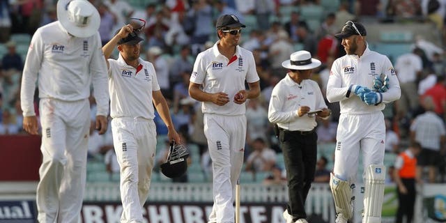 Alastair Cook (centre) and England team-mates leave the pitch at The Oval at stumps on Wednesday. Rain delayed the scheduled 11.00am local time (1000GMT) start of the second day's play in the fifth and final Ashes Test between England and Australia at The Oval on Thursday.