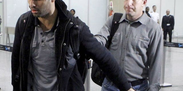 David Miranda (L), partner of Glenn Greenwald (R), a journalist with the Guardian newspaper who worked with intelligence leaker Edward Snowden, is pictured at Rio de Janeiro's international airport on his arrival on August 19, 2013. EU Justice Commissioner Viviane Reding said Thursday she shared concerns over press freedom after the British authorities detained Miranda in connection with leaks.