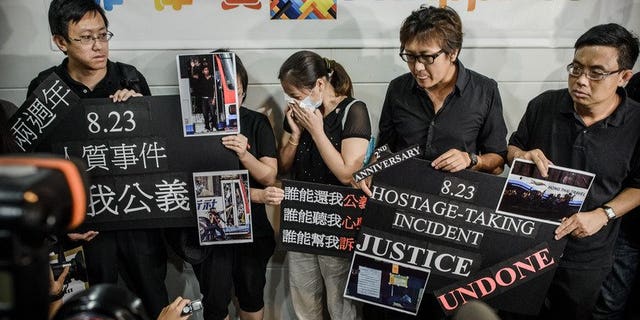 Survivors and relatives of eight Hong Kong tourists killed in a 2010 Philippine bus hostage fiasco gather outside the Philippines consulate in Hong Kong to demand an apology on August 23, 2012. Hong Kong survivors of a Manila hostage crisis and families of those killed sued the Philippine government Thursday to demand an apology and compensation, a day before the tragedy's third anniversary.