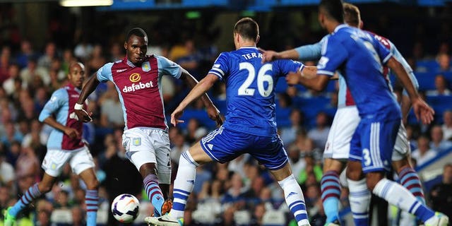 John Terry (centre) tackles Aston Villa's Christian Benteke at Stamford Bridge on Wednesday. Aston Villa manager Paul Lambert on Thursday claimed that his side were the victims of double standards after being denied a late penalty in their Premier League defeat at Chelsea.