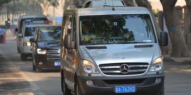 The convoy believed to be carrying disgraced politician Bo Xilai arrives at the Intermediate People's Court in Jinan, Shandong Province on August 23, 2013, for day two of his bribery trial.